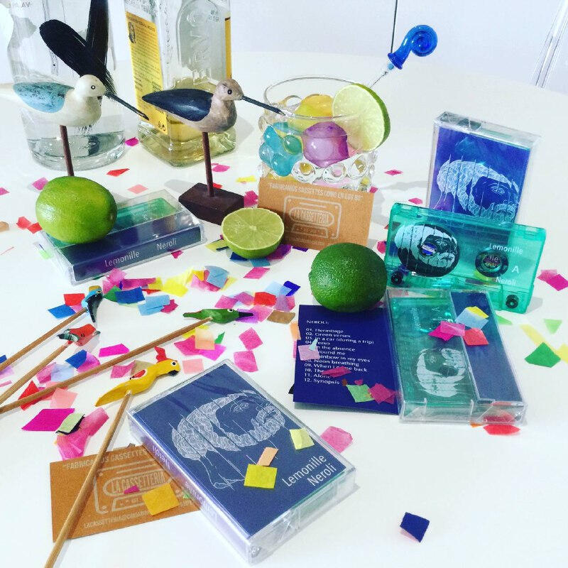 Lemonilel new album 'Neroli' in cassette format on table with lime confettis and drinks Lemonilel new album 'Neroli' in cassette format on table with lime confettis and drinks